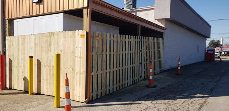 Privacy Fences Built Like They’re Our Own - Roark Fencing Wood privacy fence on a commercial property completed by Roark Fencing.