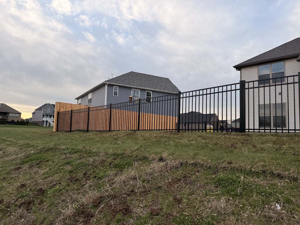 Aluminum Fencing and wooden privacy fencing completed by Roark Fencing.
