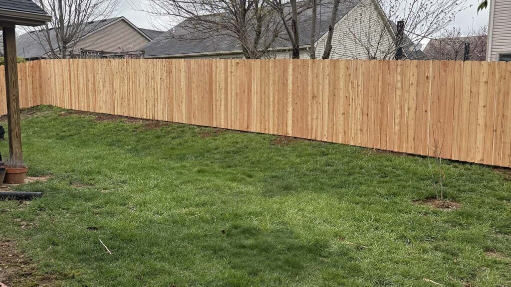 Backyard wooden privacy fencing completed by Roark Fencing.
